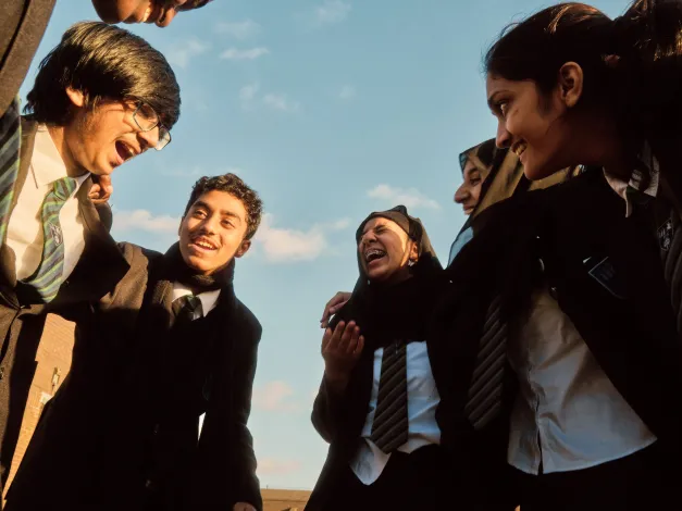 Secondary school students talking outside