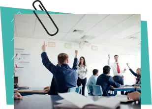 Children raising their hands in classroom