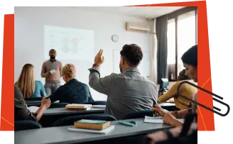 Students raising their hands in a classroom