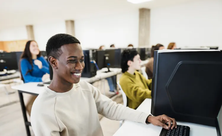 Student on computer smiling